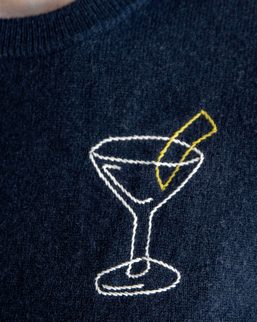 Navy blue sweater with embroidered martini glass design.